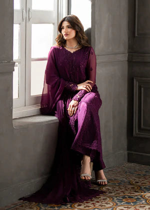 Plum embroidered chiffon suit seated pose with embroidered sleeves