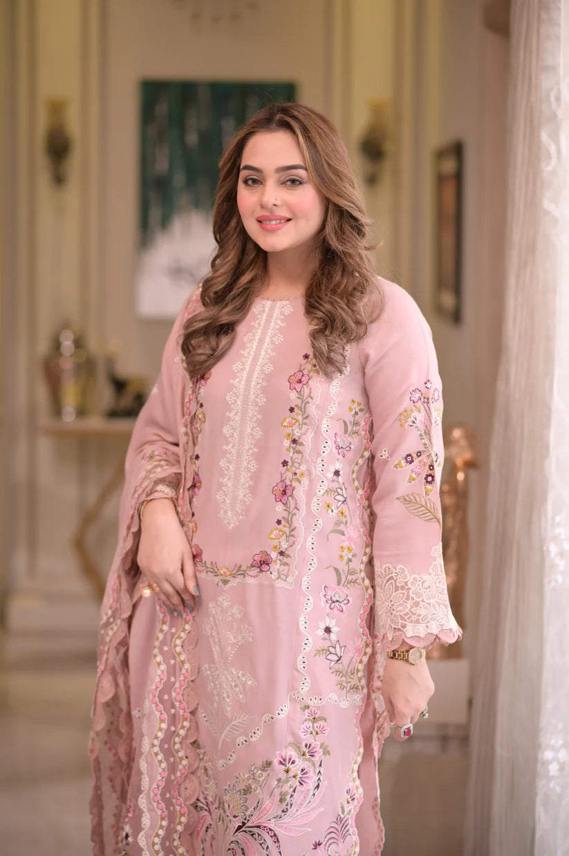 Close-up of heavy embroidered neckline and sleeve lace detail on pink pashmina suit