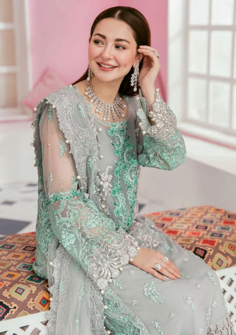 Sage green embroidered suit close-up with silver and mint floral embroidery